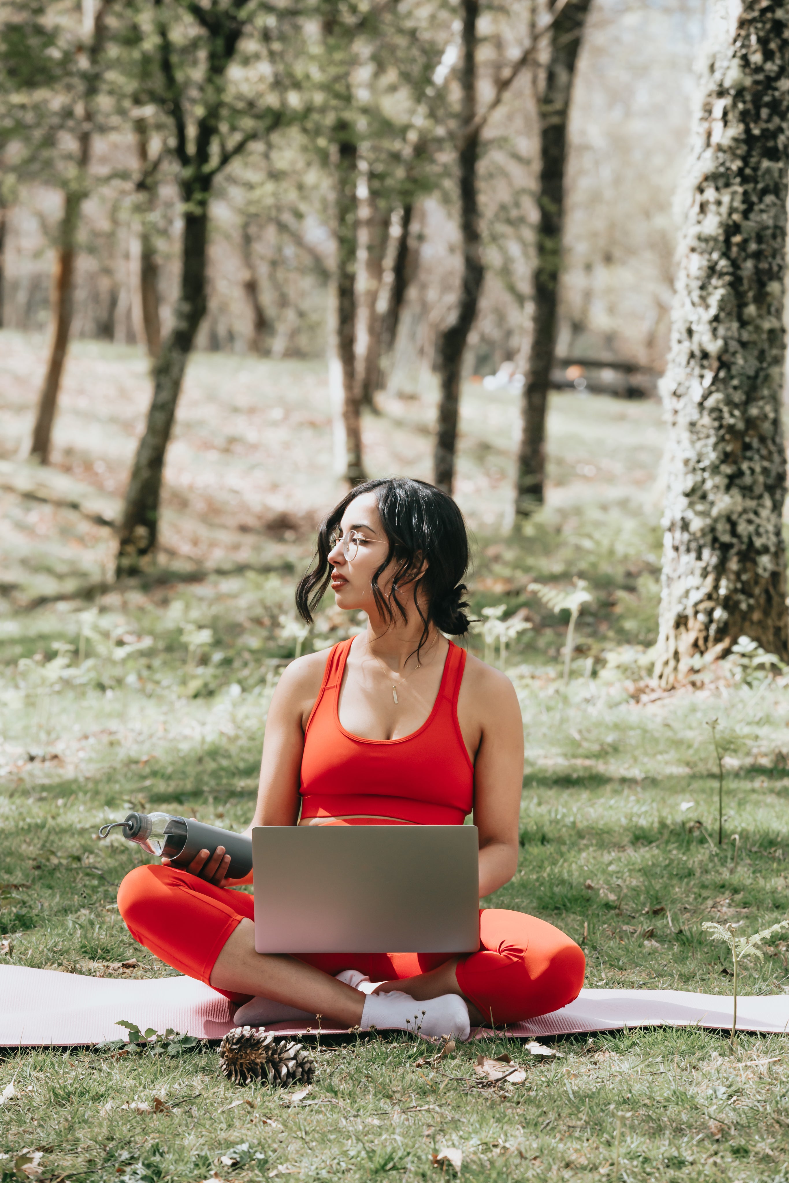 woman-in-vibrant-red-works-on-her-laptop-outdoors.jpg