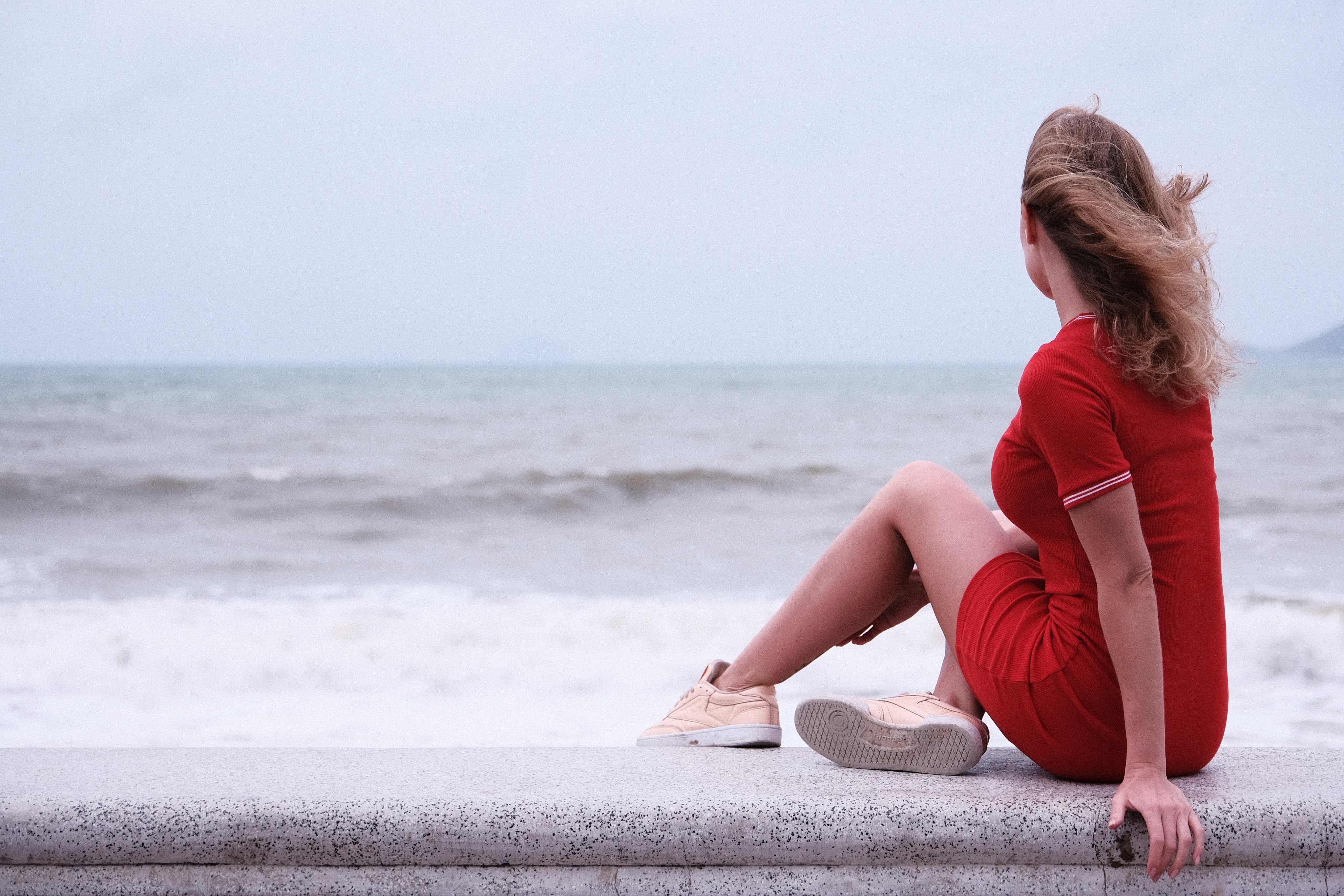 woman-sits-on-seawall.jpg